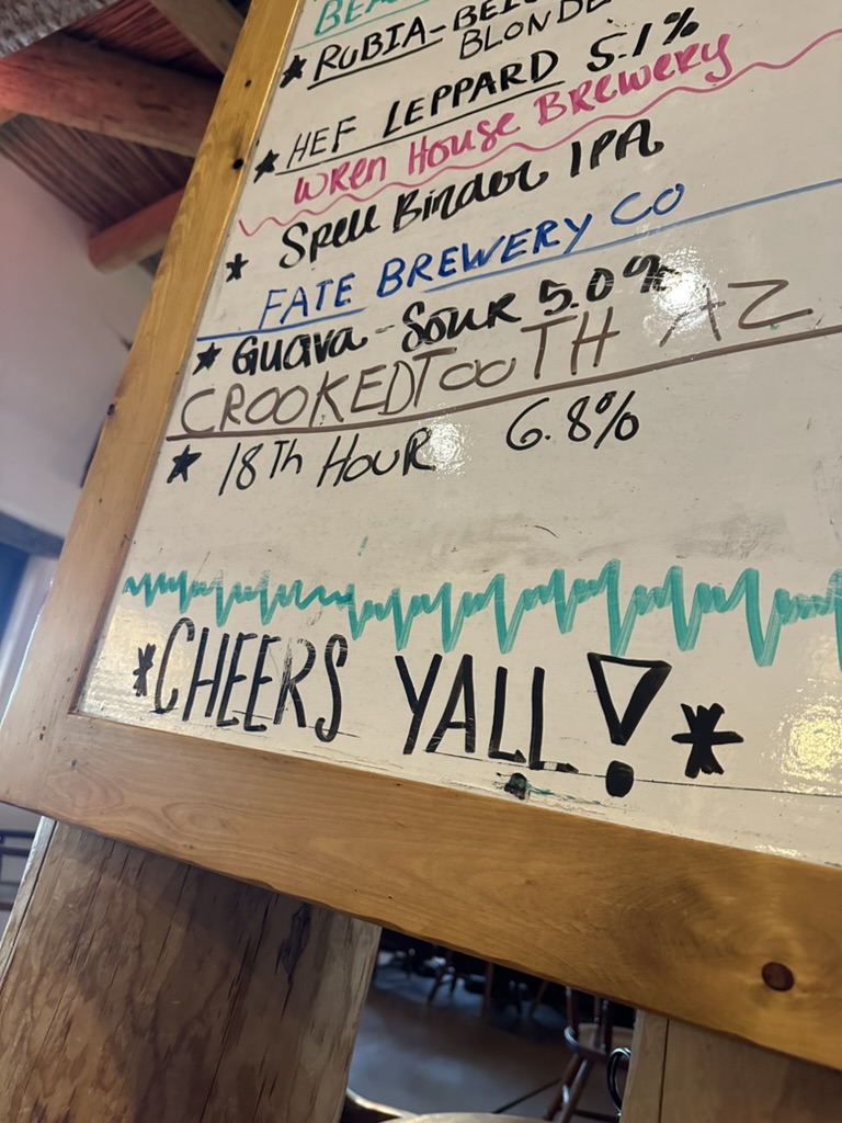 Biertafel im Saloon mit „Cheers Y'all!“